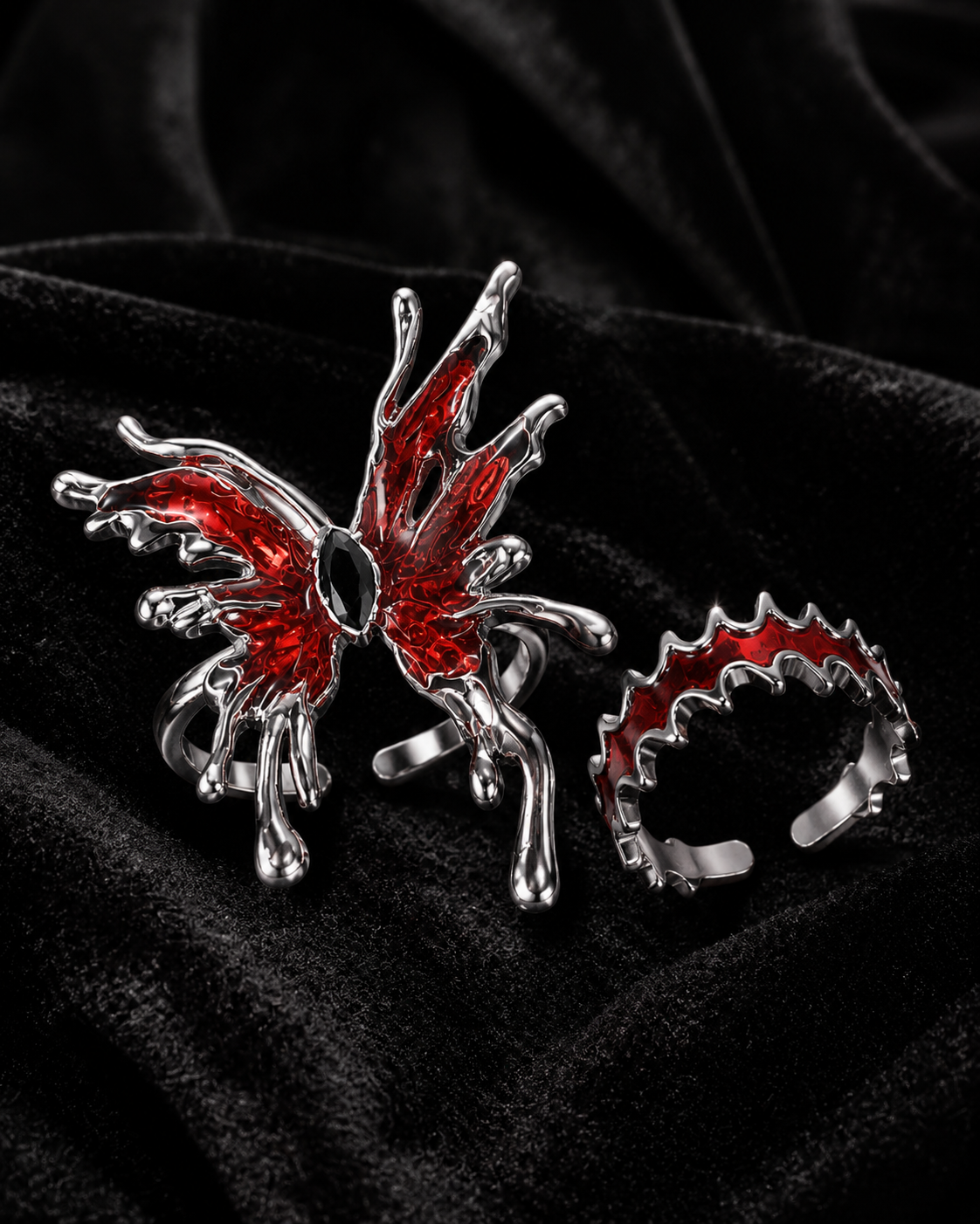 Gothic red spider ring and thorn-style open ring set on black velvet