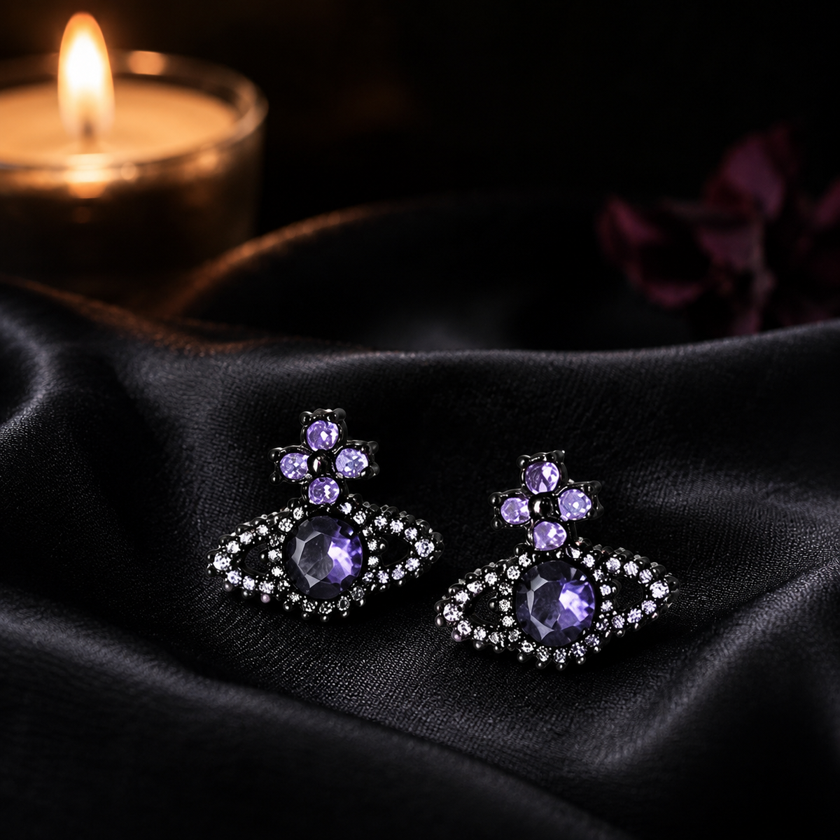 Purple cross orb sterling silver stud earrings on black satin with candlelight