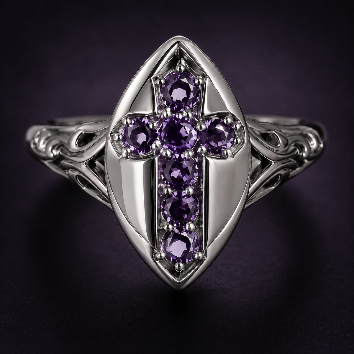 Macro close-up of purple stones and silver-tone shield details on a gothic cross ring