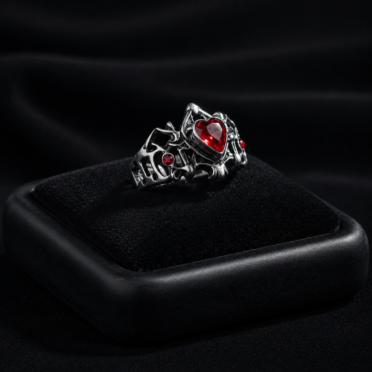 Gothic red heart ring displayed on a black velvet jewelry box