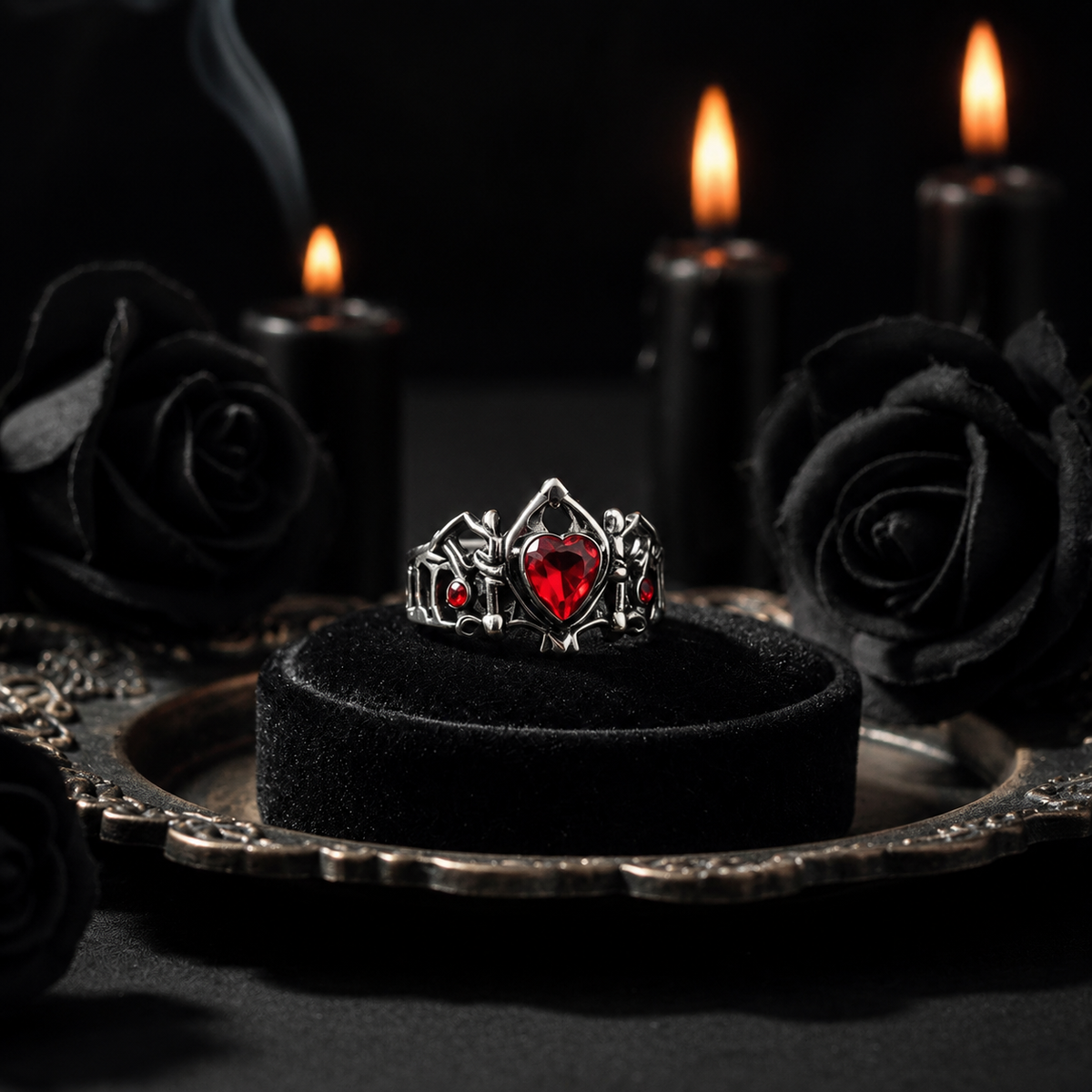 Gothic red heart ring with black roses and candles in a dark romantic setting