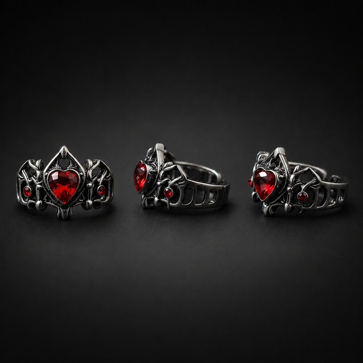 Front, side, and three-quarter views of the gothic red heart open ring