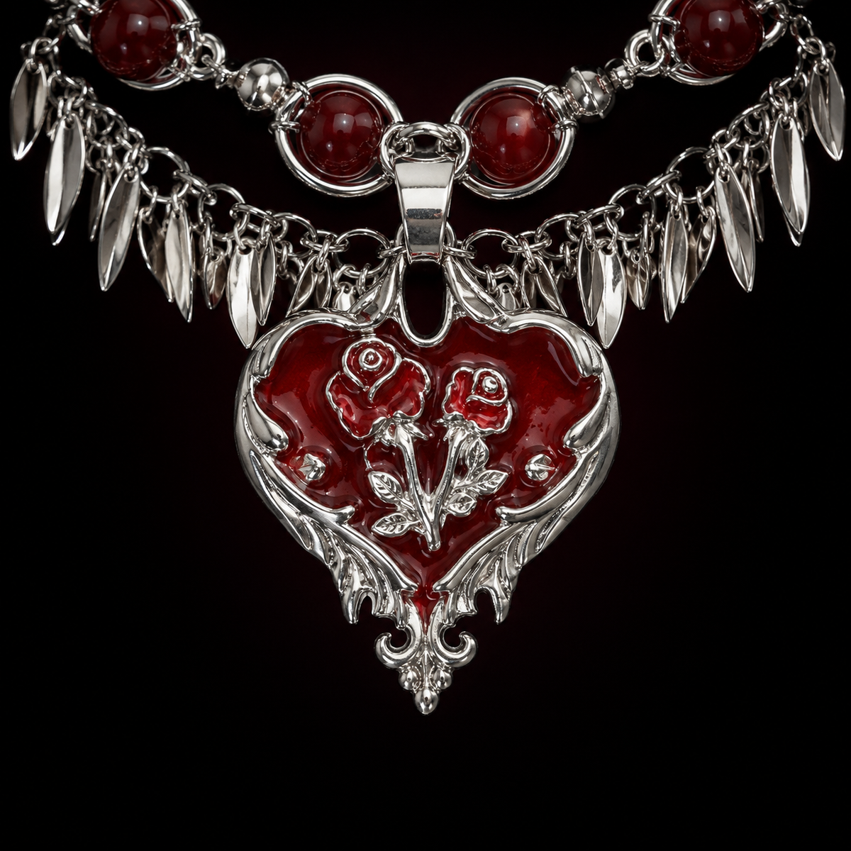 Close-up of a red heart pendant with two raised silver rose details