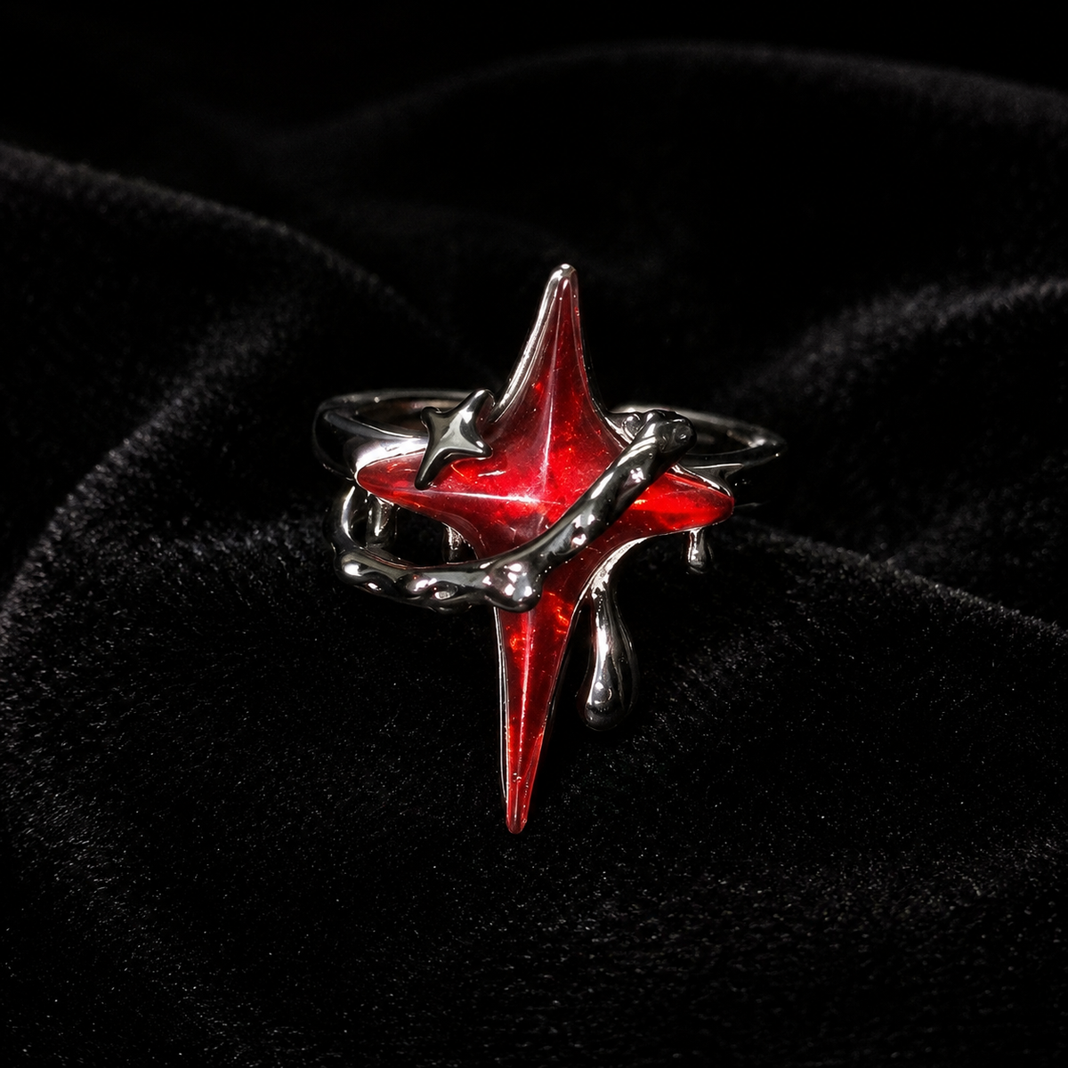 Gothic red star statement ring displayed on black velvet with crimson highlights
