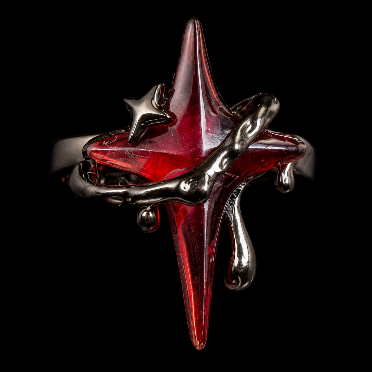 Macro close-up of a translucent red four-point star and dark gunmetal thorn framework