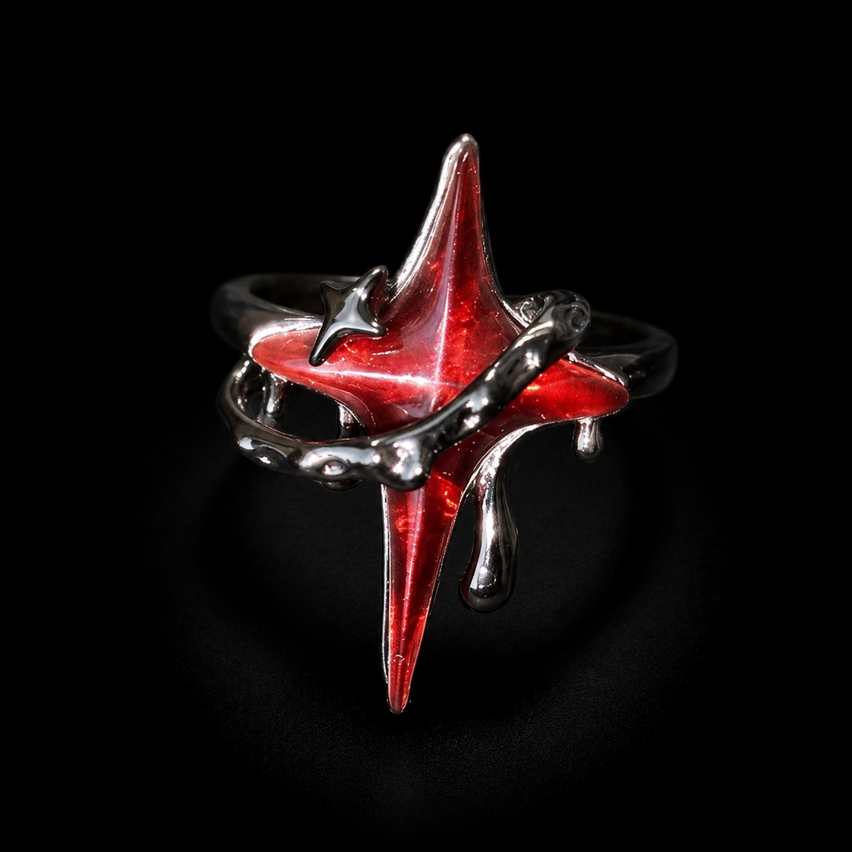 Three-quarter view of an adjustable gothic red star ring with a raised translucent centerpiece